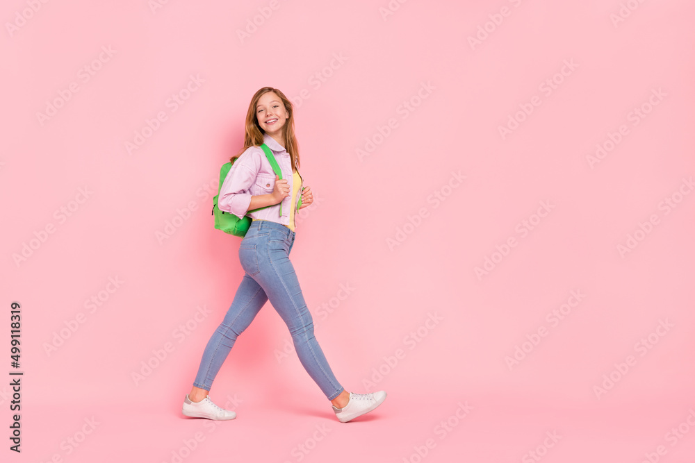 Full length profile side photo of youth attractive girl walk empty space wear casual outfit isolated over pink color background