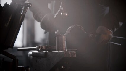 Wall Mural - Blacksmith workshop - a man shaping heated metal by hitting it with a hammer