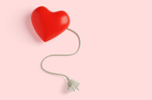 Charging For The Heart. Red Heart And Cord With Plug On A Pink Background. 3d Render