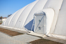 Inflatable Air Dome Stadium. Inflated Tennis Air Dome Or Tennis Bubble Arena Entrance Door Into Structure Equipped With Airlock Either Two Sets Of Parallel Doors Or A Revolving Door Or Both.