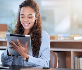 Wall Mural - Technology allows her to work wherever she is. Cropped shot of an attractive young businesswoman working on her tablet while sitting in the office.