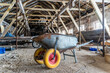 Wheelbarrow with Yellow tires inside old abandoned warehouse