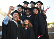 © Nikish H/peopleimages.com - Well never forget this day. Shot of a group of students taking a selfie on graduation day.