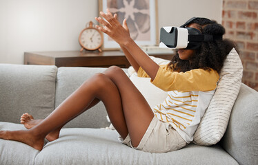 Sticker - Everyone needs an escape from this world. Shot of a young girl playing with a vr headset at home.