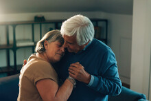 Elderly Couple Hugging And Dancing At Home - Relationship Affection And Love Concept