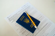 PESEL document, Ukrainian passport and a pen on white table background.