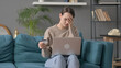 Woman with Unsuccessful Online Payment on Laptop on Sofa 