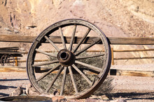 Old Wagon Wheel Leaning On A Fence