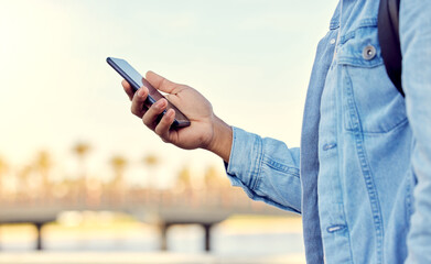 Poster - I find my way around with a little help. Cropped shot of a man using his cellphone while standing outside.