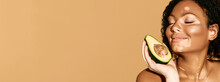 Moisturizing And Care For Pigmented Skin Using Cosmetics With Avocado, Web Banner. Smiling Woman With Vitiligo Holds Avocado Near Her Spotted Face