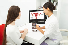 Gynecology, Consultation Of Gynecologist, Women's Health. Gynecologist Showing To Woman Ultrasound Of Her Ovaries During Female Patient Visit To Gynecology