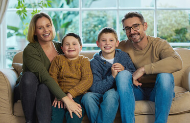 Wall Mural - Your family are all you have. Shot of a family relaxing together in the living room.