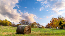 Autumn Rural Countryside Landscape With Trees With Colorful Fall Leaves And Large Round Haybales In A Field On A Hillside In Illinois
