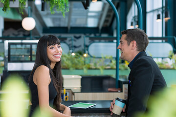 Portrait of a smiling young businessman and woman. Happy business people talking in Co Working space office.