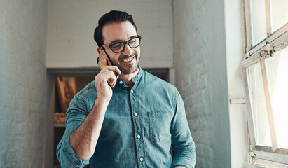 Poster - Yes, thats me.... Cropped shot of a handsome young male architect taking a phonecall while standing in an office.