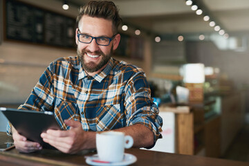 Poster - I come for the wifi... but the coffees good too. Portrait of a young man using his tablet while sitting by the window in a cafe.