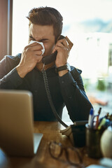 Poster - It might be time to schedule that appointment with the doctor. Shot of a young businessman blowing his nose while speaking on a phone in an office.