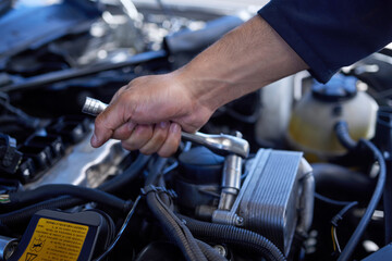Poster - Safety first. High angle shot of an unrecognizable male mechanic working on the engine of a car during a service.