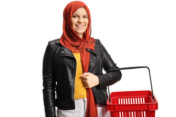 Canvas Print - Young female with a hijab holding an empty shopping basket