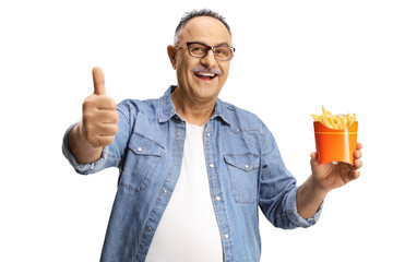 Poster - Happy mature man holding french fries and gesturing a thumb up sign