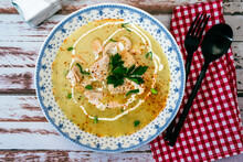 An Exquisite Dish With A Homemade Cream Of Poultry Soup With Chicken Pieces, Parsley And Cream On A Rustic Or Country Style Wooden Table. Natural And Simple Food Concept.