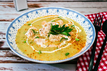 Exquisite Dish With A Homemade Cream Of Poultry Soup With Chicken Pieces, Parsley And Cream On A Rustic Or Country Style Wooden Table. Natural And Simple Food Concept. High View