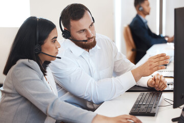 Poster - Try doing it like this next time. Shot of two call centre agents working together on a computer in an office.