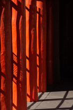 Abstract Design Of Of Black Shadows On Vibrant Orange Wooden Pillars Shadows Of Fence Cast On Pillars In Afternoon Sunlight In Down Town Santa Fe New Mexico Near Plaza Colorful Vertical Backdrop 