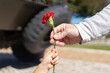 25 of April, celebration of 50 Years, Portugal freedom day. Revolution of the Carnations 1974 Father giving a red clove flower to his son. 