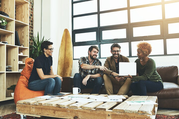 Poster - Inspiration is waiting online. Shot of a group of designers using a laptop in their brainstorming session.