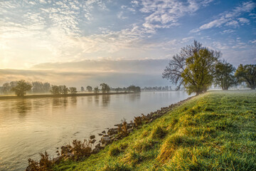 The river danube between the rural towns Osterhofen and Winzer in lower bavaria during sunrise in early spring