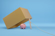 Piggy bank in a wood box trap isolated on blue background. 3D illustration.