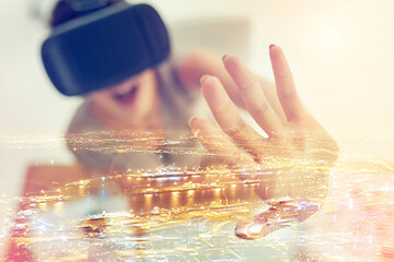 Canvas Print - Forecasting and redefining the future. Multiple exposure shot of young businesswoman wearing a VR headset superimposed over a cityscape.