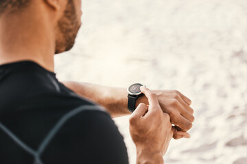 Make time for things that make you better. Cropped shot of a man checking his watch while out for a workout.