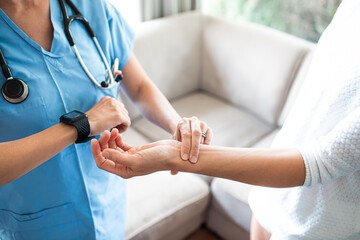 Nurse checking patient pulse 