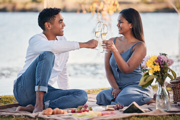 Poster - Heres to over everlasting love. Shot of a young couple making a toast while on a picnic at a lakeside.