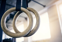 The best equipment to work on both strength and flexibility. Closeup shot of gymnastic rings in a gym.