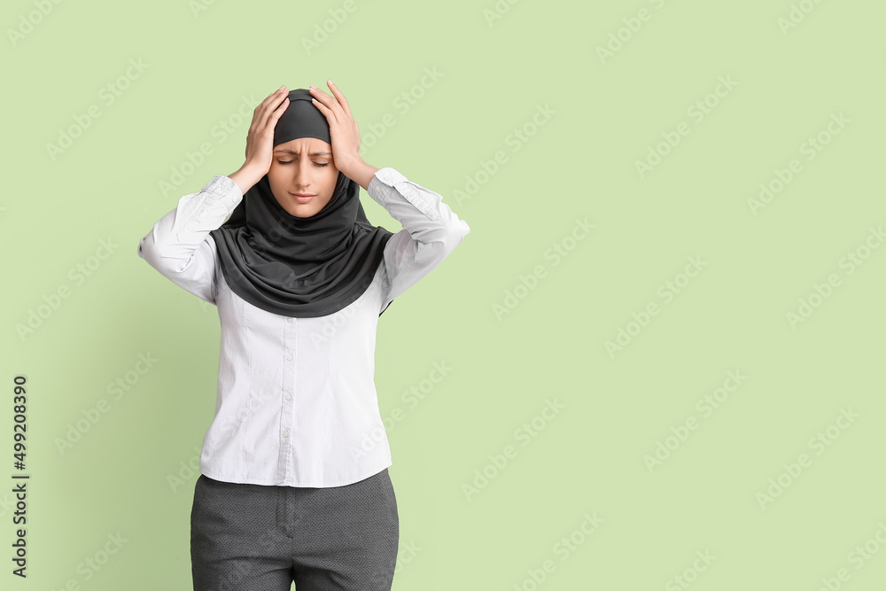 Stressed Muslim secretary on color background
