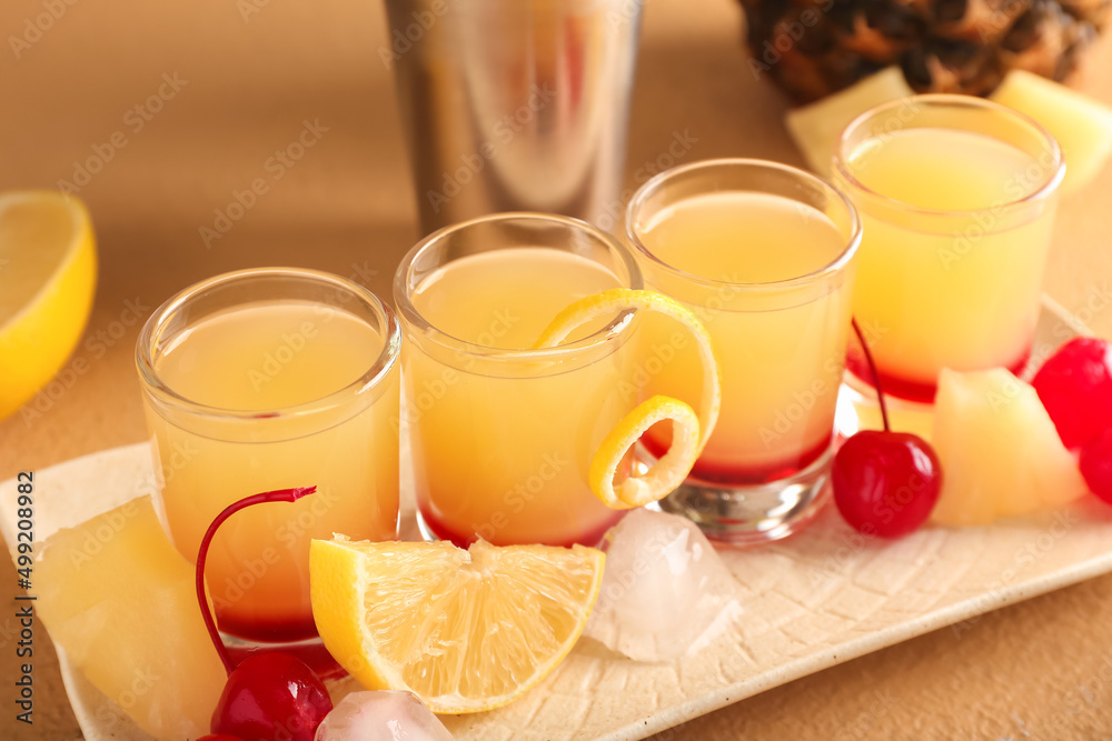Plate with tasty Pineapple Upside Down Cake Shots on beige background