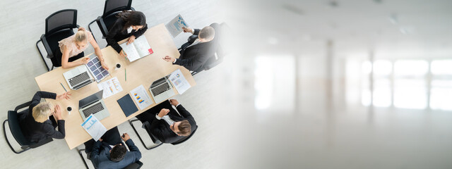 Business people group meeting shot from top widen view in office . Profession businesswomen, businessmen and office workers working in team conference with project planning document on meeting table .