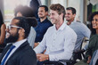 © AS/peopleimages.com - Hes learning a lot. High angle shot of a group of businesspeople sitting in the conference room during a seminar.
