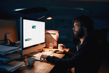 Poster - Some late night programming. Cropped shot of a young computer programmer working late in the office.