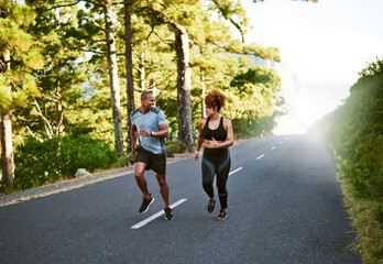 Poster - having a partner makes it so much easier. shot of a young couple out running together.