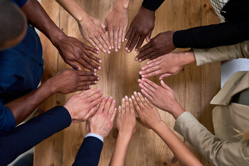 Canvas Print - Every contribution makes us better. High angle shot of a group of unidentifiable businesspeople making a circle with their hands in the office.