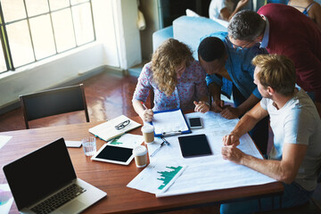 Poster - Teamwork is the best way have a productive workday. Shot of a diverse group of businesspeople collaborating on a project in a modern office.