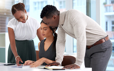 Poster - Running through the final draft together. Shot of a group of businesspeople going through paperwork together in an office.