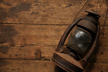 Amazing Vintage Kerosene Lamp On A Shabby Wooden Floor. Extremely Dark Background, Brown Color