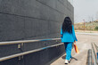 © Dani D.G - Unrecognizable woman walking along wall