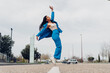 © Dani D.G - Black woman on tiptoes standing on road