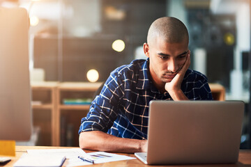 Aufkleber - Feeling trapped in a life of monotony. Cropped shot of a young designer looking bored while working at his office desk.
